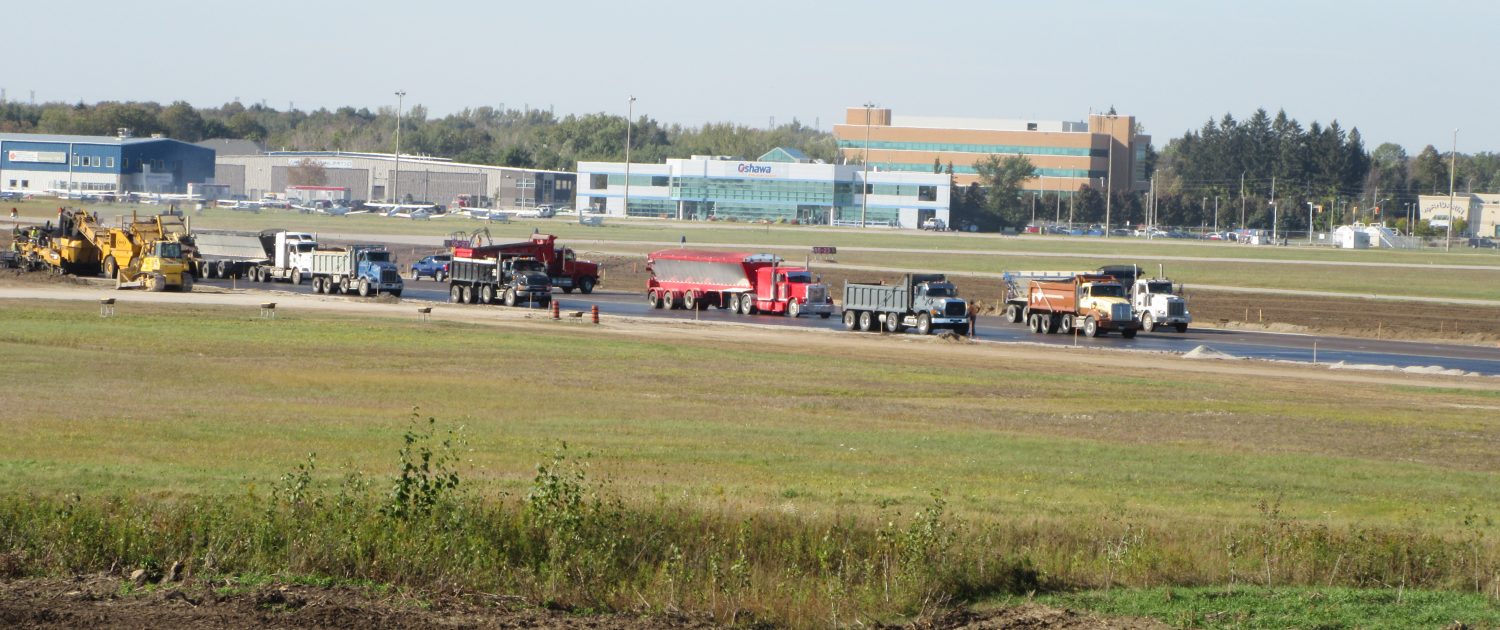 Oshawa Executive Airport job site with lots of trucks